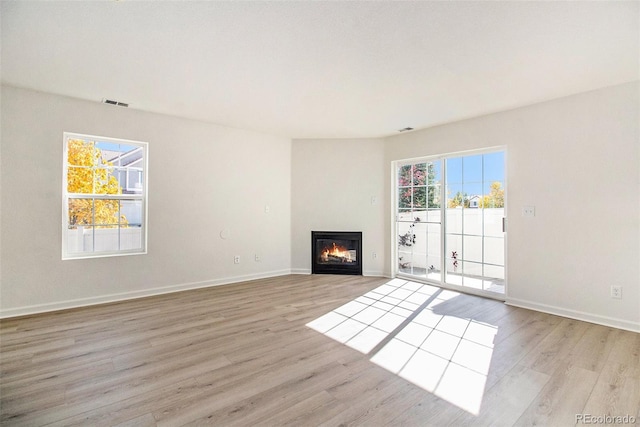 unfurnished living room with light hardwood / wood-style floors