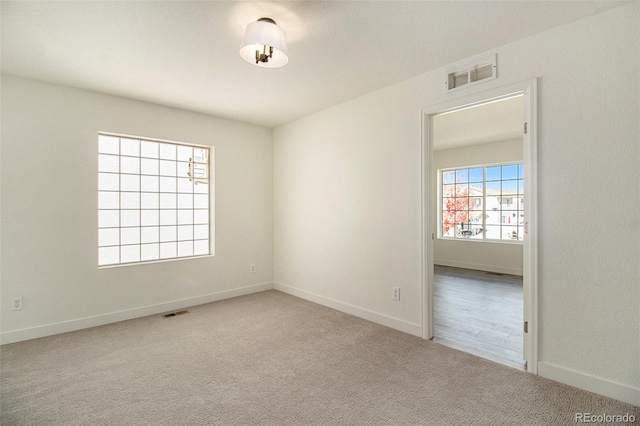 spare room with light colored carpet