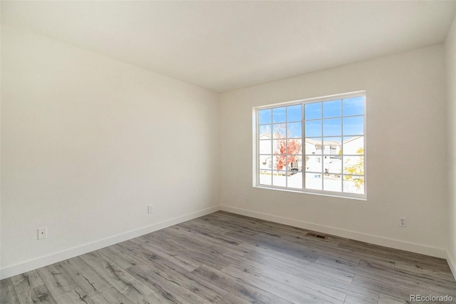 spare room featuring light hardwood / wood-style floors