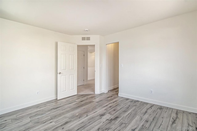 empty room with light hardwood / wood-style floors