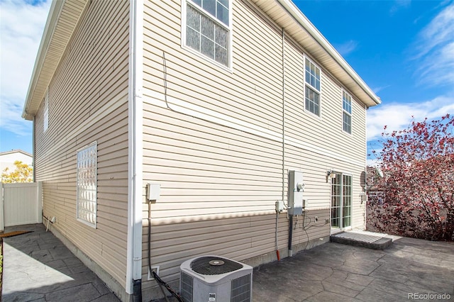 view of property exterior with a patio area and central AC unit