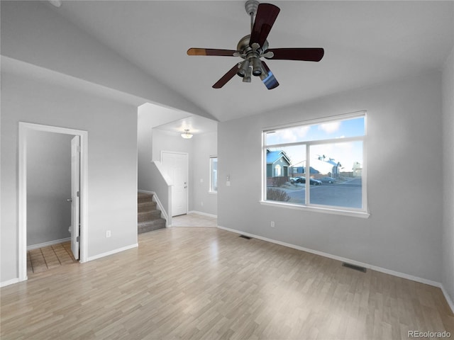 unfurnished living room with light wood-type flooring, vaulted ceiling, and ceiling fan