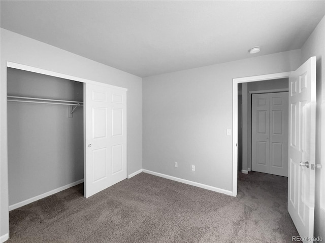 unfurnished bedroom featuring carpet floors and a closet