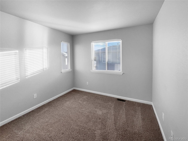 unfurnished room featuring carpet flooring