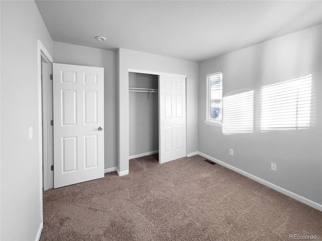 unfurnished bedroom with a closet and carpet