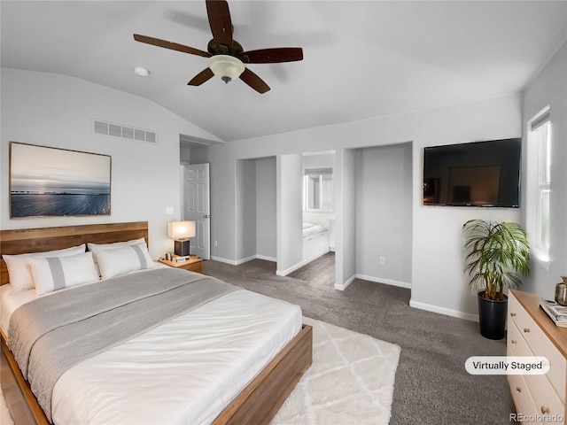 carpeted bedroom with ensuite bathroom, ceiling fan, and vaulted ceiling