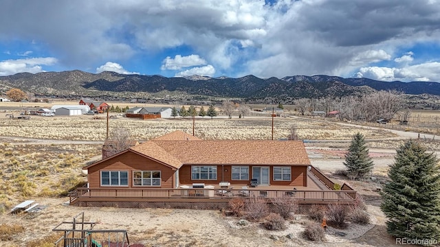 back of house featuring a deck with mountain view