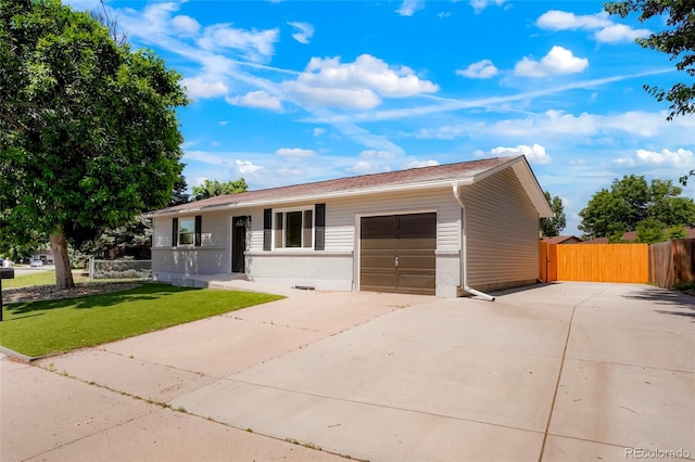 5554 Crystal Way, Denver, CO 80239 - ranch-style house with concrete driveway, a garage, and brick siding