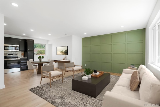 5554 Crystal Way, Denver, CO 80239 - living room with a decorative wall, light wood finished floors, and recessed lighting