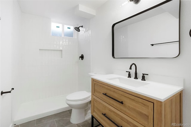 5554 Crystal Way, Denver, CO 80239 - bathroom featuring vanity, tiled shower, and tile patterned floors
