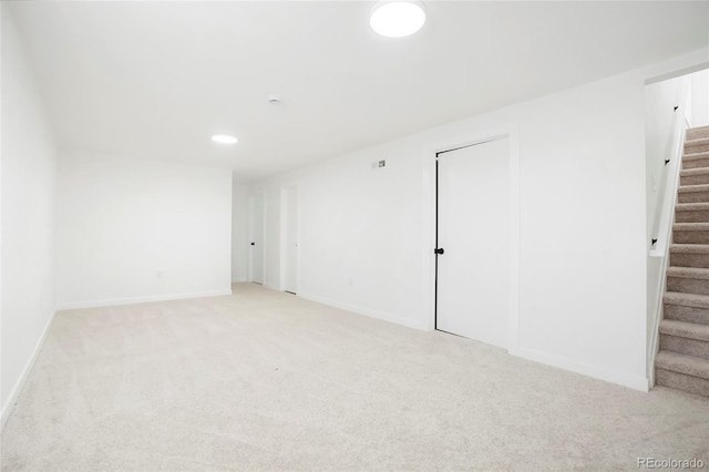 5554 Crystal Way, Denver, CO 80239 - basement featuring stairs, light colored carpet, and recessed lighting
