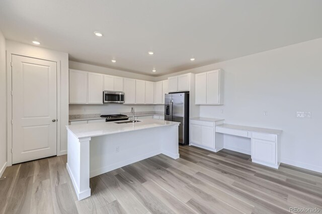 15153 W Dequesne Ave, Morrison, CO 80465 - kitchen with appliances with stainless steel finishes, a sink, light countertops, white cabinets, and recessed lighting