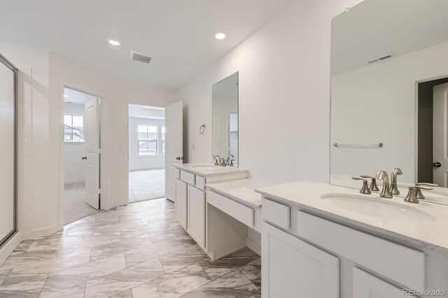 15153 W Dequesne Ave, Morrison, CO 80465 - bathroom featuring two vanities, recessed lighting, marble finish flooring, a shower with shower door, and baseboards