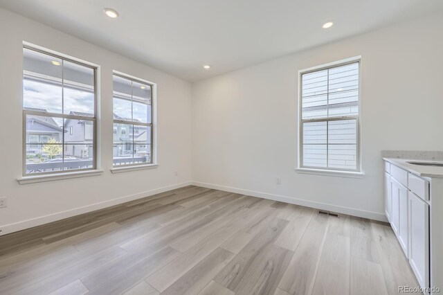 15153 W Dequesne Ave, Morrison, CO 80465 - unfurnished room with light wood finished floors, baseboards, and recessed lighting