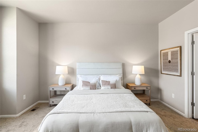 carpeted bedroom with baseboards and visible vents