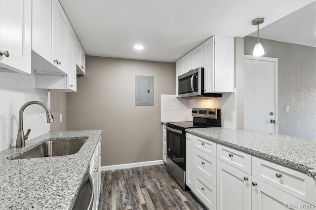 1777 S Pitkin St Unit A, Aurora, CO 80017 - kitchen with appliances with stainless steel finishes, electric panel, decorative backsplash, dark wood finished floors, and a textured wall