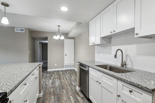 1777 S Pitkin St Unit A, Aurora, CO 80017 - kitchen featuring stainless steel dishwasher, tasteful backsplash, dark wood-type flooring, white cabinets, and a chandelier