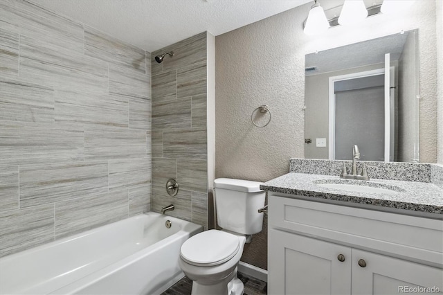 1777 S Pitkin St Unit A, Aurora, CO 80017 - full bath with a textured wall, vanity, shower / washtub combination, a textured ceiling, and wood finished floors
