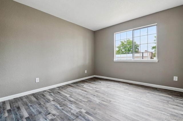 1777 S Pitkin St Unit A, Aurora, CO 80017 - spare room with wood finished floors and baseboards