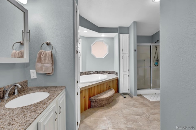 248 Copperdale Ln, Golden, CO 80403 - full bath featuring a textured wall, tile patterned flooring, vanity, a bath, and a stall shower
