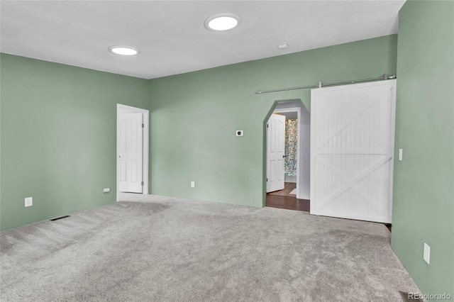 248 Copperdale Ln, Golden, CO 80403 - unfurnished bedroom featuring arched walkways, visible vents, and carpet