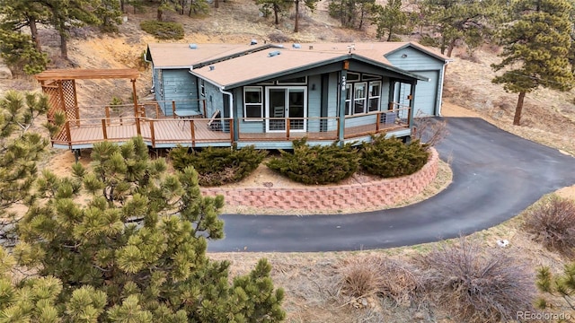 248 Copperdale Ln, Golden, CO 80403 - view of front of house with a garage, a sunroom, a deck, and aphalt driveway