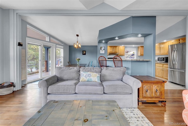 248 Copperdale Ln, Golden, CO 80403 - living area featuring lofted ceiling, light wood-style flooring, and a chandelier