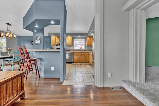 248 Copperdale Ln, Golden, CO 80403 - kitchen with stainless steel appliances, plenty of natural light, and light wood-style floors
