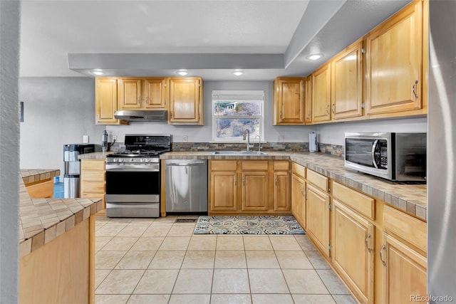 248 Copperdale Ln, Golden, CO 80403 - kitchen featuring appliances with stainless steel finishes, under cabinet range hood, recessed lighting, light tile patterned floors, and light brown cabinetry