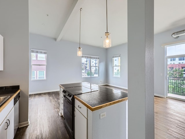 2501 15th St Unit 3D, Denver, CO 80211 - kitchen with black electric range oven, dishwasher, dark wood finished floors, white cabinets, and beamed ceiling