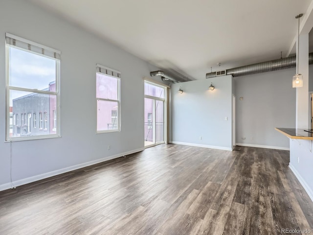 2501 15th St Unit 3D, Denver, CO 80211 - unfurnished living room with dark wood-type flooring and baseboards