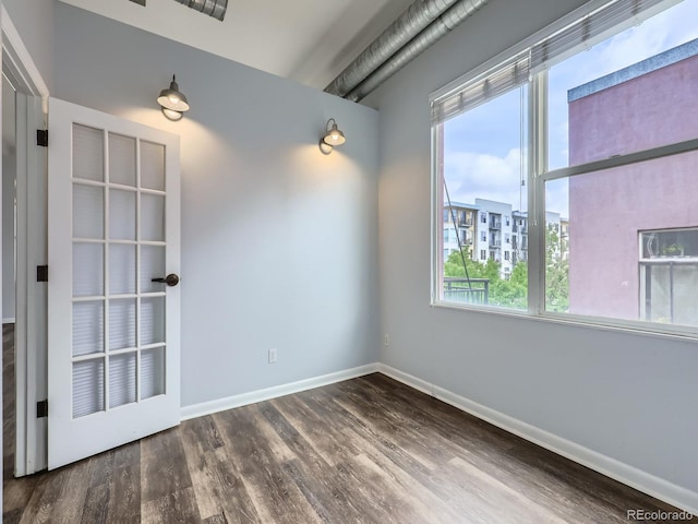 2501 15th St Unit 3D, Denver, CO 80211 - empty room featuring healthy amount of natural light, dark wood-style flooring, and baseboards