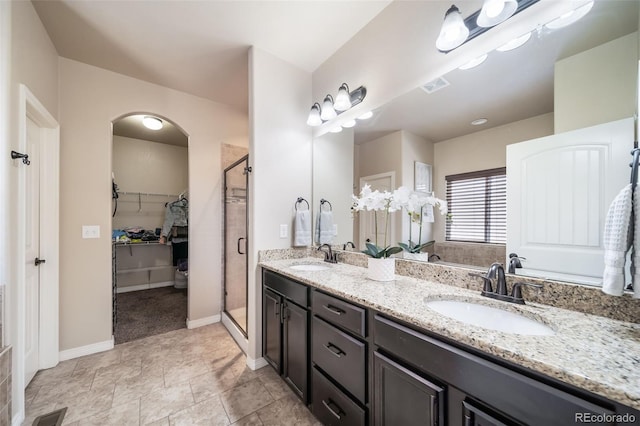 bathroom featuring vanity and a shower with shower door