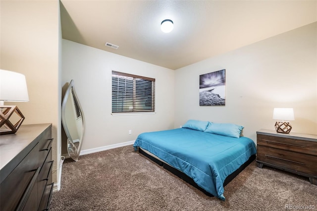 bedroom featuring dark colored carpet