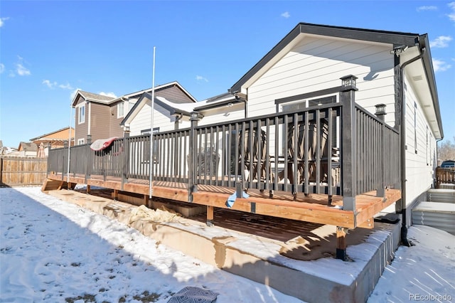 snow covered house with a deck