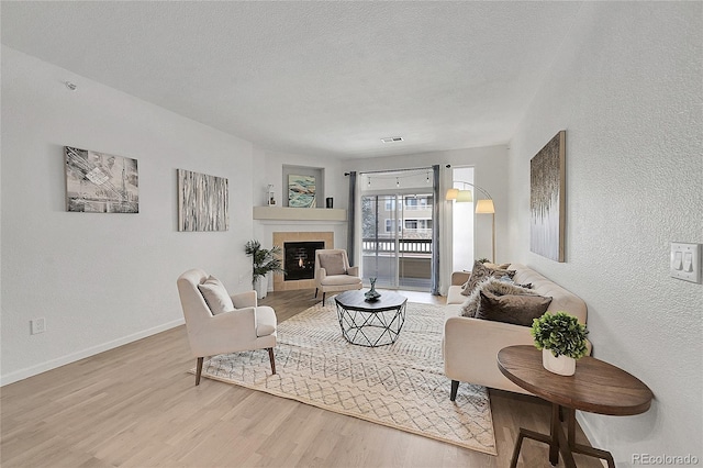 living room featuring a textured ceiling and hardwood / wood-style flooring