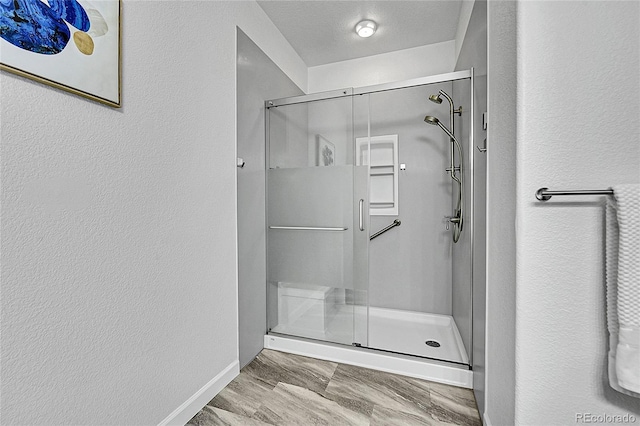 bathroom with a textured ceiling and walk in shower