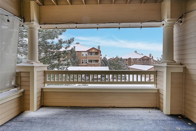 view of snow covered back of property