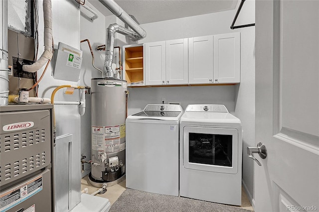 laundry room with cabinets, separate washer and dryer, and water heater