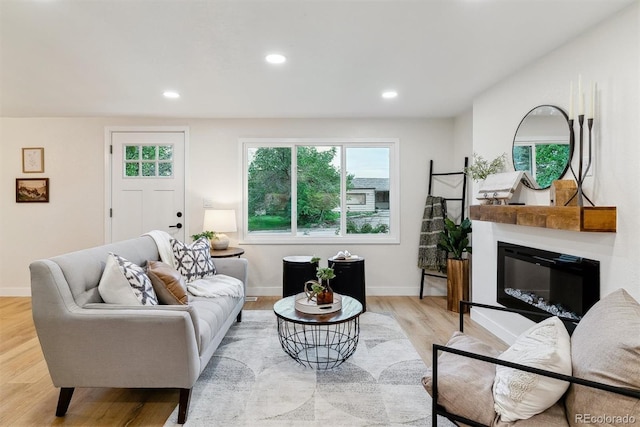 1815 Ingalls St, Lakewood, CO 80214 - living room featuring light wood finished floors, recessed lighting, baseboards, and a glass covered fireplace