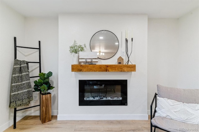 1815 Ingalls St, Lakewood, CO 80214 - living room featuring wood finished floors, a glass covered fireplace, and baseboards