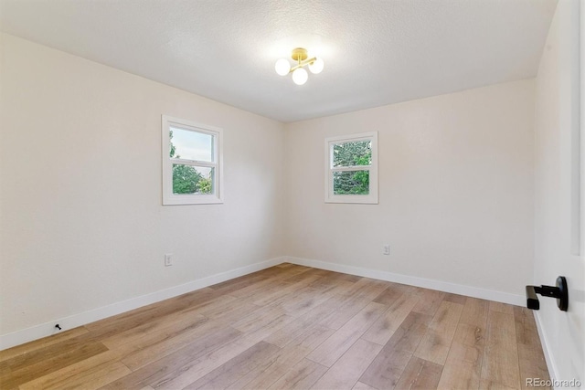 1815 Ingalls St, Lakewood, CO 80214 - empty room with healthy amount of natural light, light wood-type flooring, and baseboards