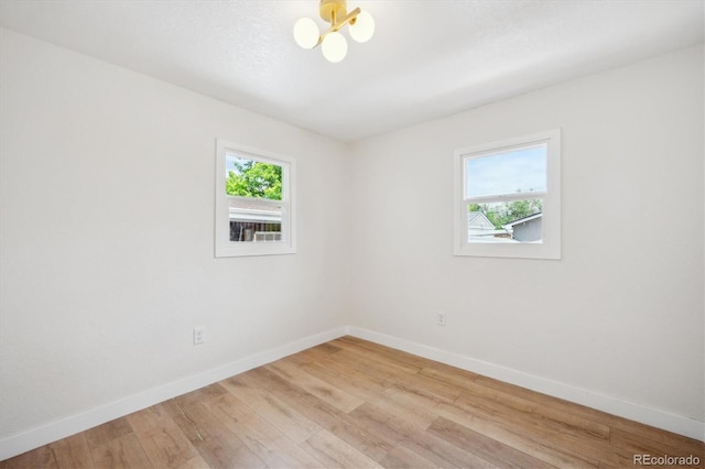 1815 Ingalls St, Lakewood, CO 80214 - spare room with healthy amount of natural light, baseboards, and light wood-style flooring