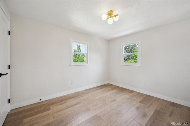 1815 Ingalls St, Lakewood, CO 80214 - unfurnished room featuring healthy amount of natural light, wood finished floors, and baseboards