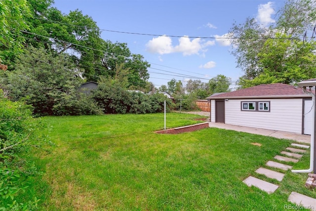 1815 Ingalls St, Lakewood, CO 80214 - view of yard with a garage, an outdoor structure, and a patio