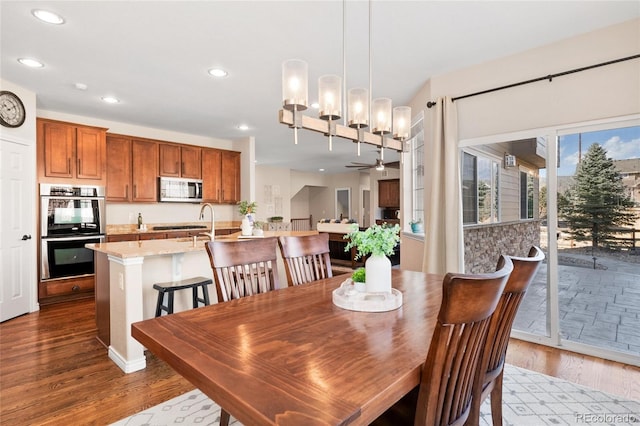 dining space with ceiling fan, dark wood-type flooring, and recessed lighting