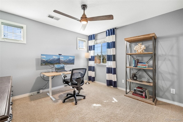 office space with a wealth of natural light, carpet, visible vents, and baseboards