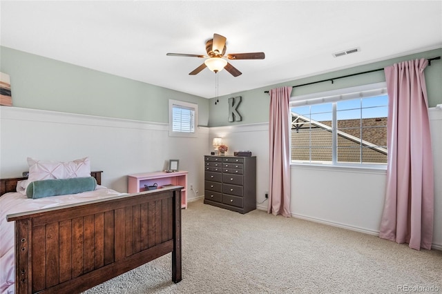 bedroom featuring carpet floors, visible vents, and a ceiling fan