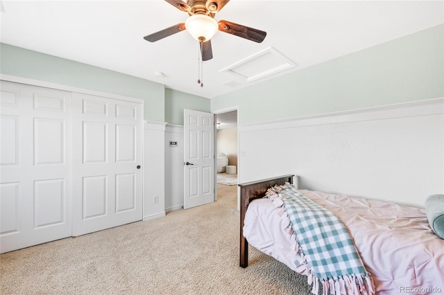 bedroom featuring carpet floors, attic access, a closet, and a ceiling fan