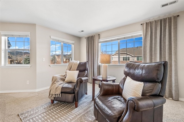 sitting room featuring carpet floors, visible vents, and baseboards